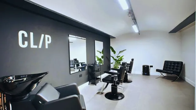 Inside: black chairs, mirrors and a wash basin