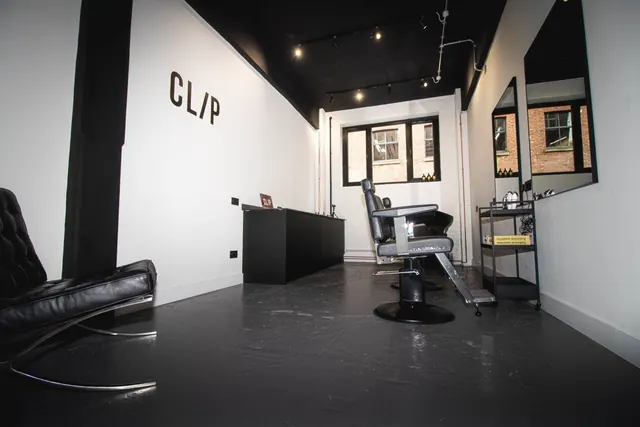 The shop from the doorway: a barber chair and the counter